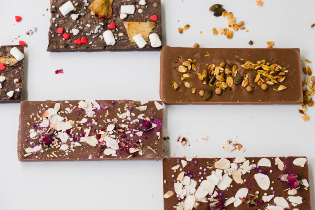 different type chocolate bars white backdrop