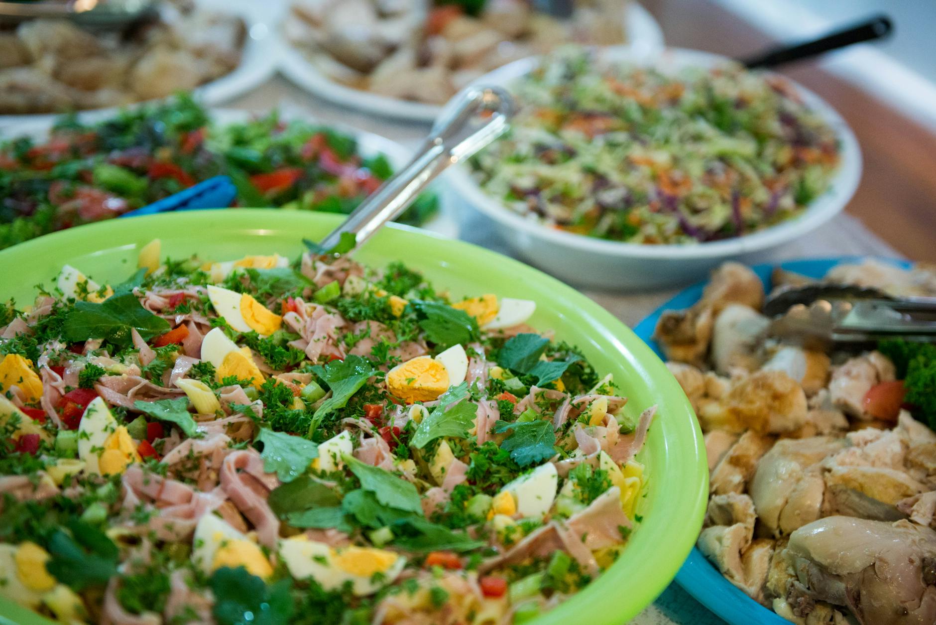 festive table with assorted salads and dishes in bowls