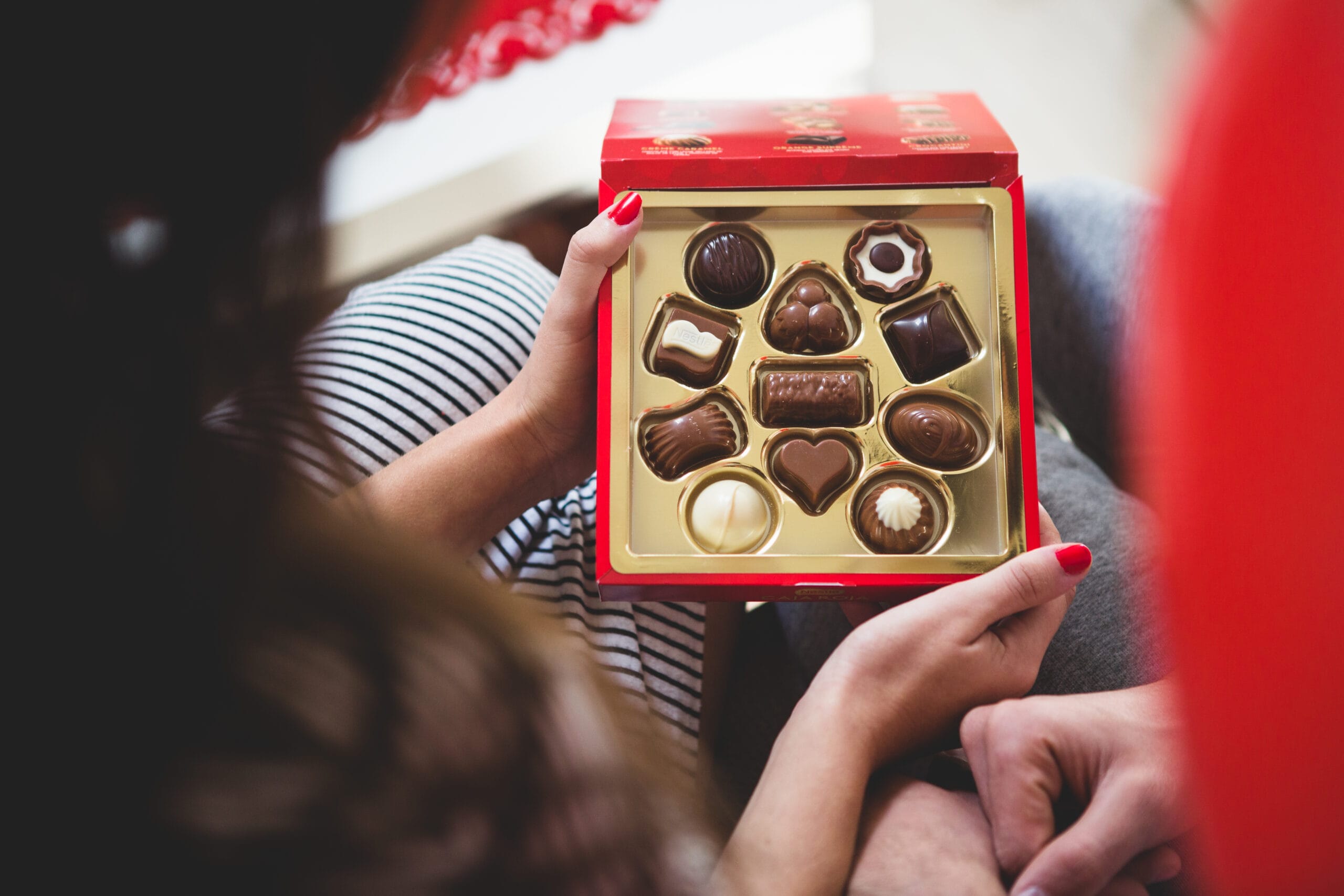 woman opening box chocolates